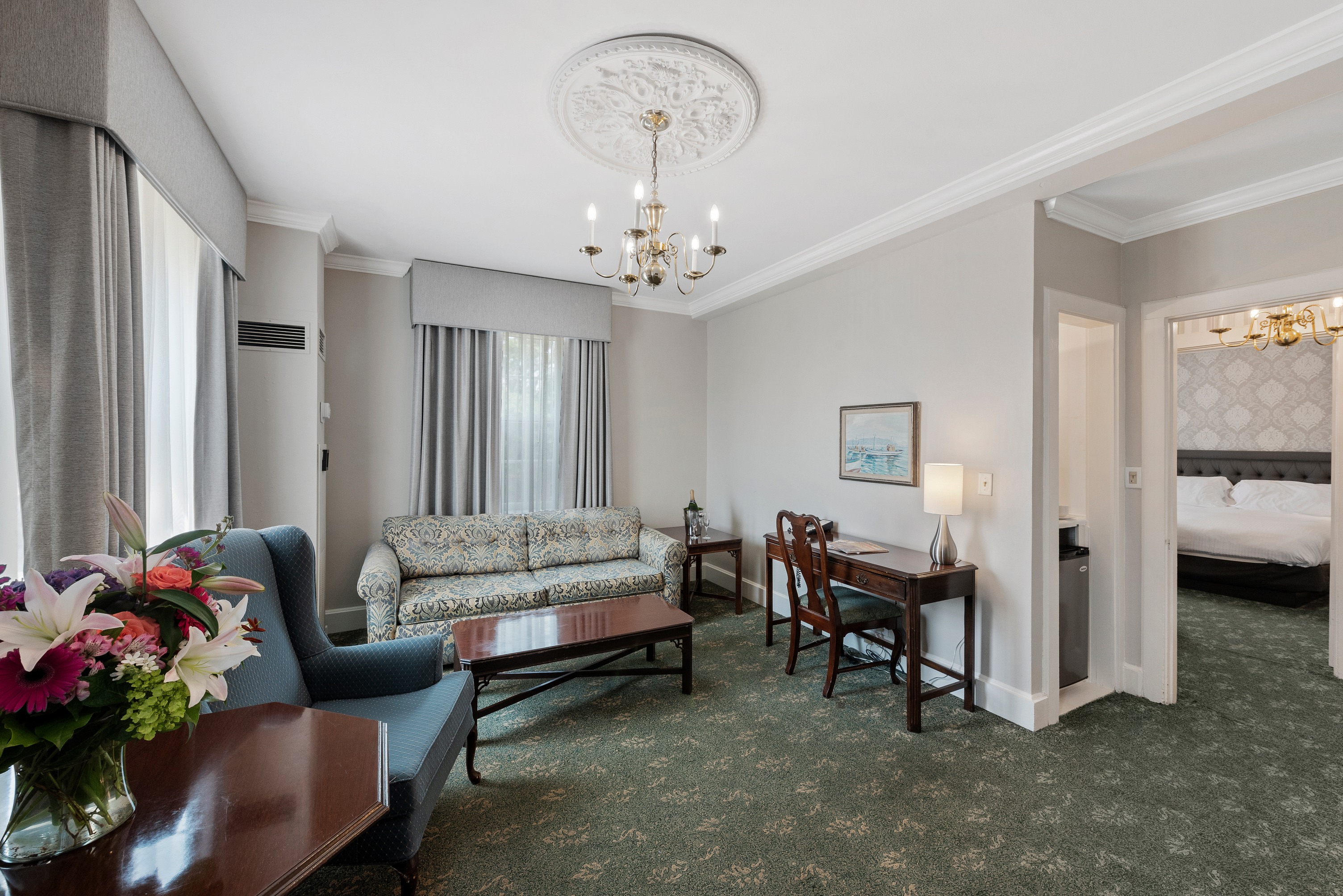Image of Suite Seating Area with couch, coffee table, writing desk, and accent chair. Hawthorne Hotel, a member of Historic Hotels of America since 1991, located in Salem, Massachusetts