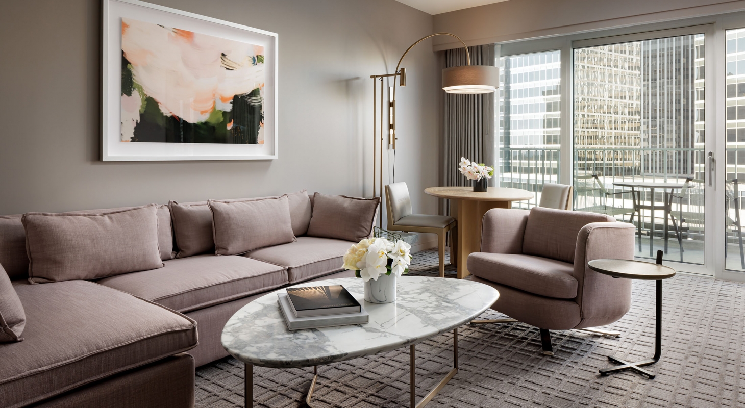 Image of Suite Living Room with Lavender Couch and Marble Table with Gold Accents at Fairmont Century Plaza, in Los Angeles, California, opened in 1961 and a member of Historic Hotels of America since 2022.