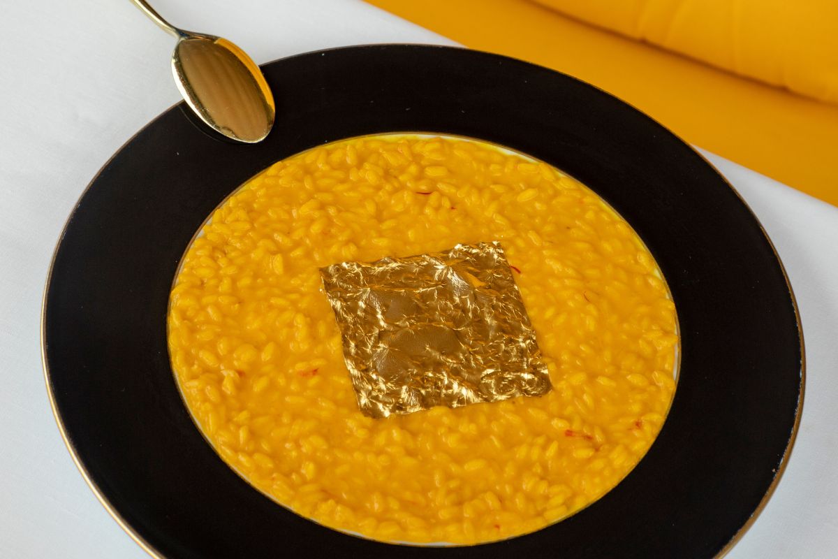 Image of Saffron Risotto with gold leaf served at La Terrazza Gualtiero Marchesi, Grand Hotel Tremezzo, 1910, a member of Historic Hotels Worldwide, Lake Como, Tremezzo, Italy