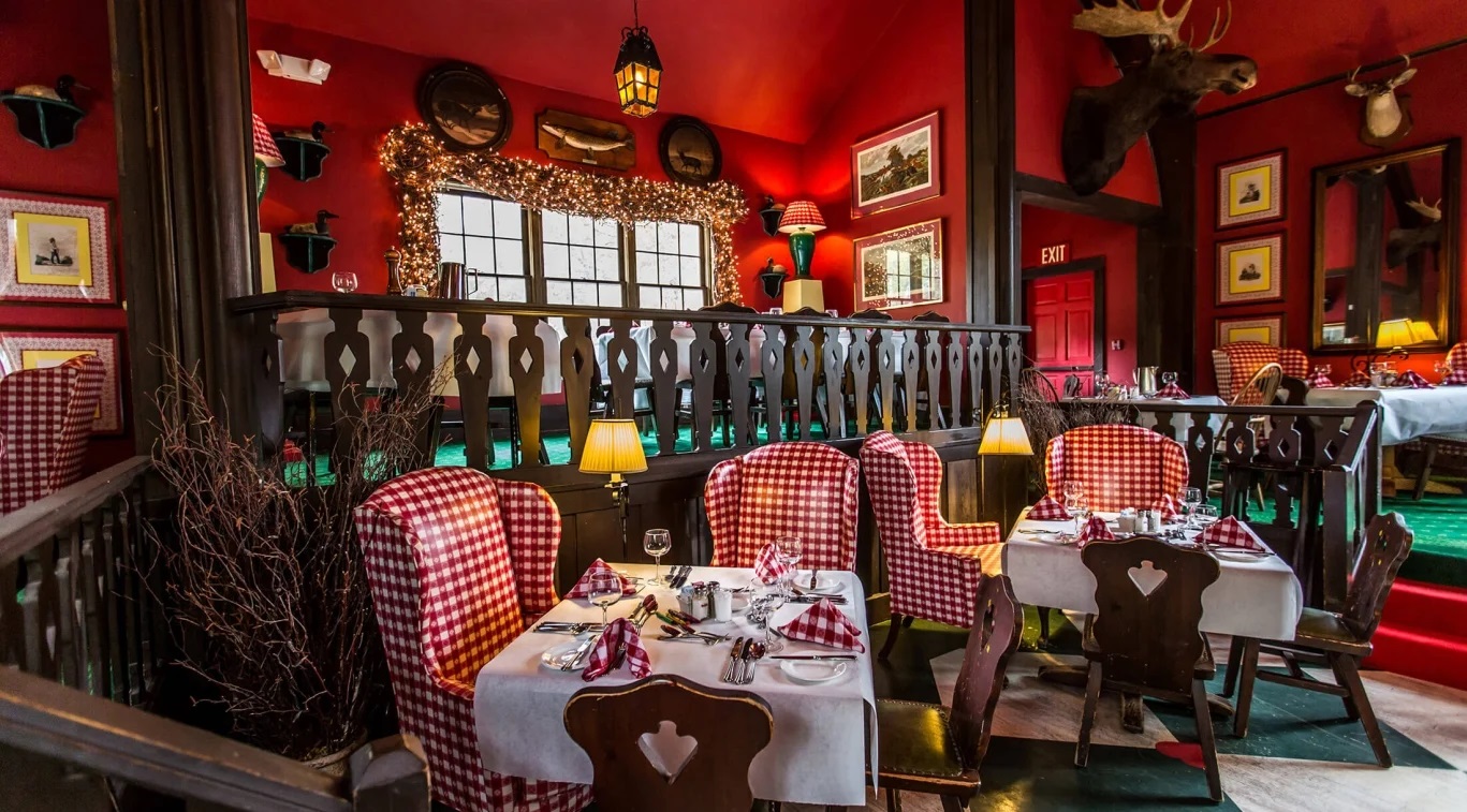 Image of Wood’s Restaurant with checkered flooring, and bright cherry walls for a fun dining experience. Grand Hotel, a member of Historic Hotels since 2001, dates to 1886. It is located in Mackinac Island, Michigan.