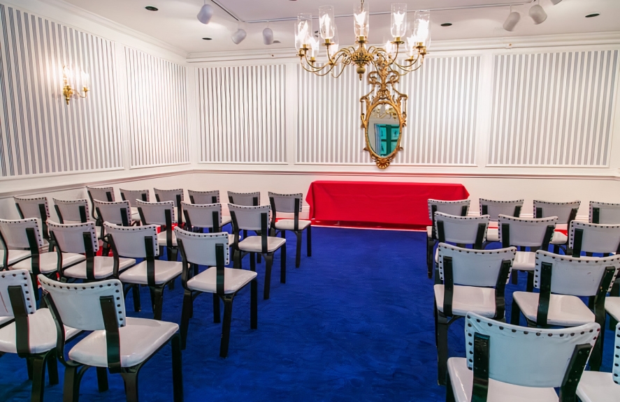 Image of the Gerald R. Ford Conference Room with royal blue carpeting and gold accented furnishings. Grand Hotel, a member of Historic Hotels since 2001, dates to 1886. It is located in Mackinac Island, Michigan.