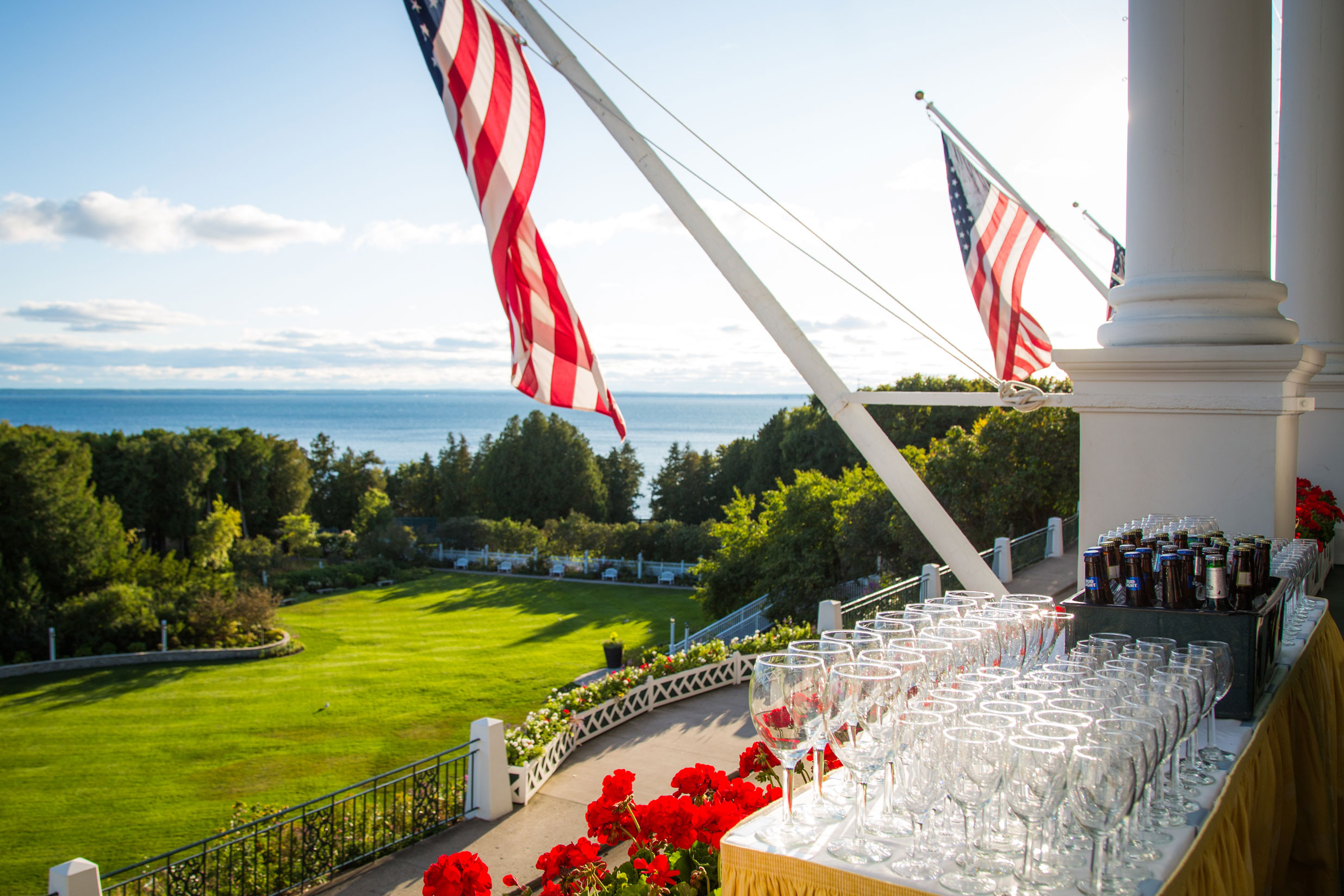 Image of a wedding reception taking place out on the front porch of the hotel with views overlooking the Mackinac Straits.