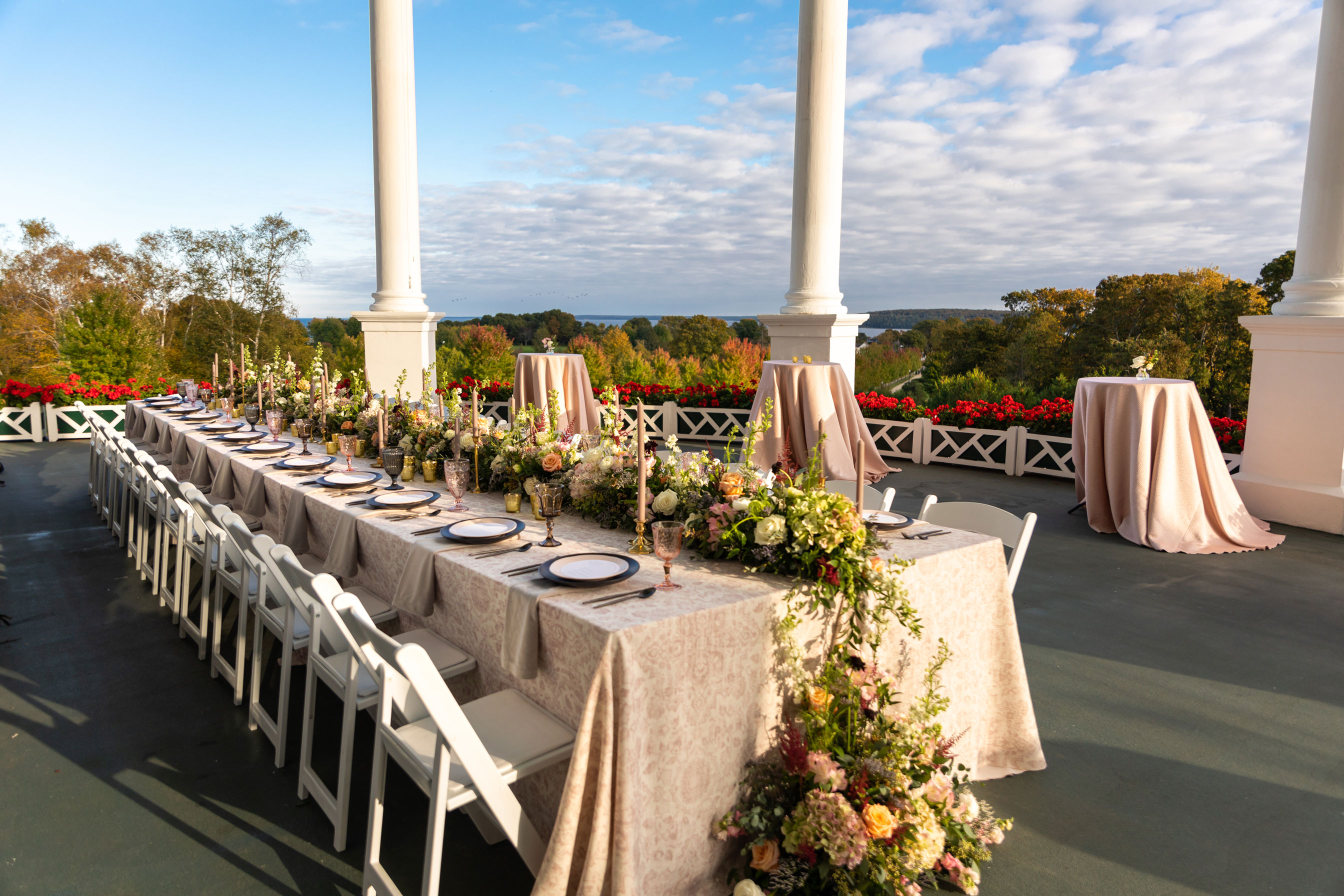 Image of a wedding reception taking place out on the front porch of the hotel with views overlooking the Mackinac Straits.