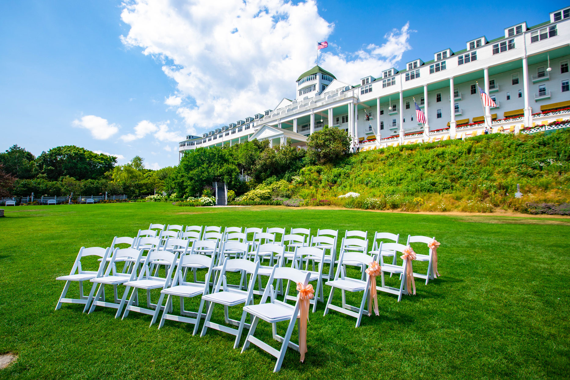 Image of the Tea Garden Wedding Ceremony with chairs out on the lawn. Grand Hotel, a member of Historic Hotels since 2001, dates to 1886. It is located in Mackinac Island, Michigan.