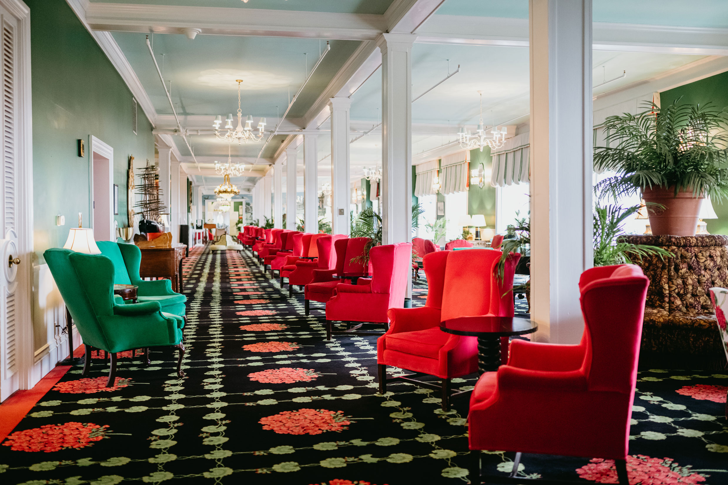Image of the Parlor at the Grand Hotel with red and green velvet fabric couches. Grand Hotel, a member of Historic Hotels since 2001, dates to 1886. It is located in Mackinac Island, Michigan.