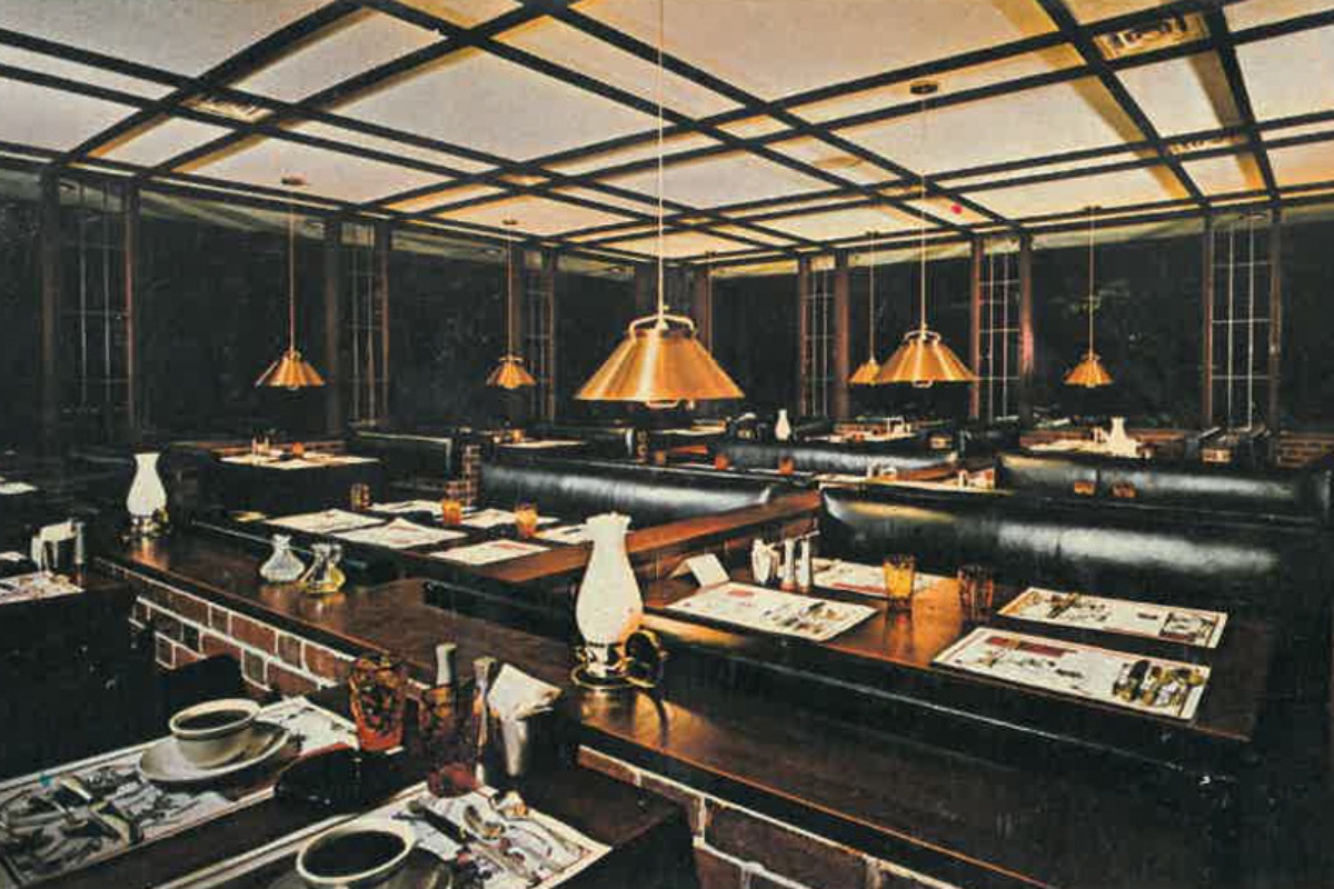 Historic image of the dining room at The Nassau Inn (1756), a member of Historic Hotels of America since 2024. Pictured are several set tables under an ornate ceiling.