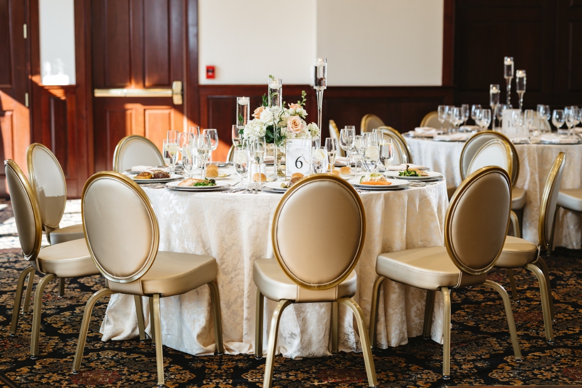 Image of the Prince William Ballroom at the Nassau Inn (1756) a member of Historic Hotels of America since 2024. Pictured is a table and chairs set for an event.