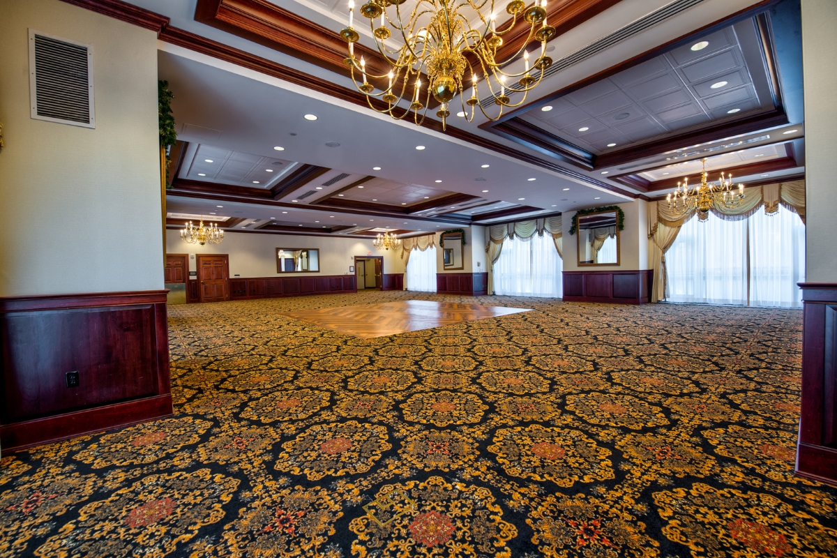 Image of the Prince William Ballroom at the Nassau Inn (1756) a member of Historic Hotels of America since 2024. Pictured is a large carpeted room with a dance floor.