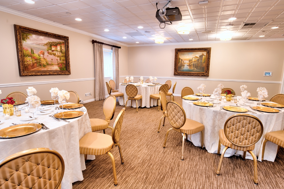 Image of the Princeton Room at the Nassau Inn (1756) a member of Historic Hotels of America since 2024. Pictured is a large room with paintings and set tables.