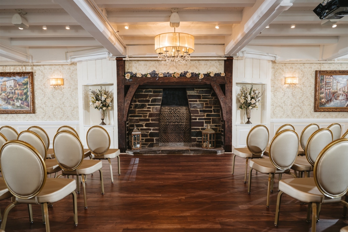 Image of the Senior Room at the Nassau Inn (1756) a member of Historic Hotels of America since 2024. Pictured are rows of chairs set up in front of a large hearth.