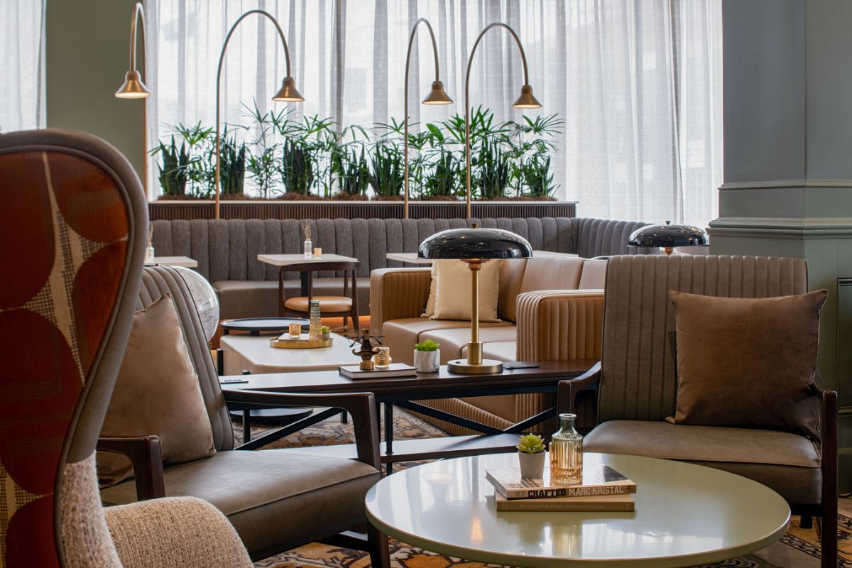 Image of cafe seating at Hilton Richmond Downtown (1885), a member of Historic Hotels of America since 2024. Pictured are several chairs set around coffee tables.