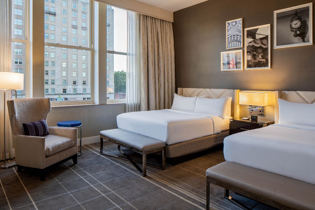 Image of a room at Hilton Richmond Downtown (1885), a member of Historic Hotels of America since 2024. Pictured are two large beds and other furnishings.