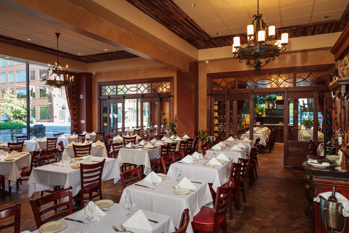 Image of a restaurant at Hilton Richmond Downtown (1885), a member of Historic Hotels of America since 2024. Pictured are many set dining tables in a bright room.