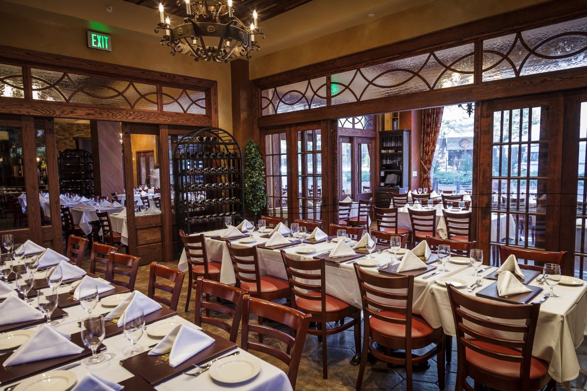 Image of a restaurant at Hilton Richmond Downtown (1885), a member of Historic Hotels of America since 2024. Pictured are many tables grouped together in a large room.