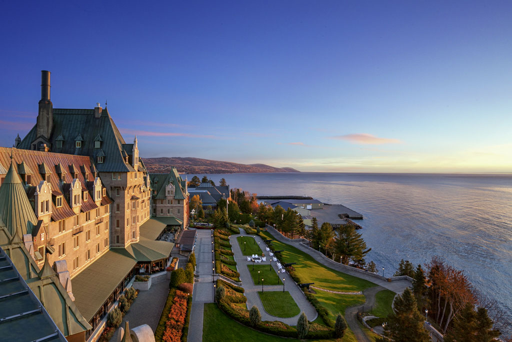 Image of Fairmont Le Manoir Richelieu exterior and the St. Lawrence River, 1899, a member of Historic Hotels Worldwide since 2018, Charlevoix, Quebec, Canada